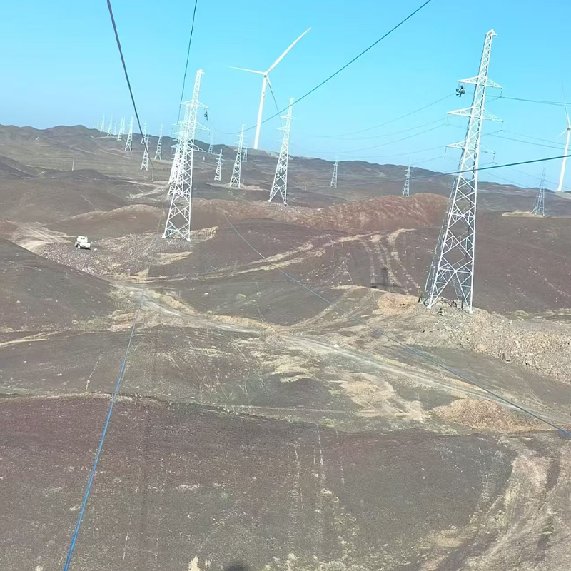 How can transmission line towers be rationally laid out in mountainous terrain to reduce construction difficulties?